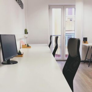 Bright and modern coworking office space in Budapest, showcasing minimalist design and contemporary furniture.