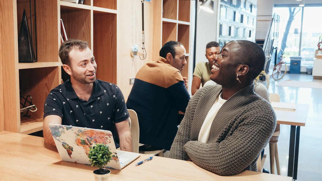 Colleagues engaging in a lively discussion at a contemporary coworking space.