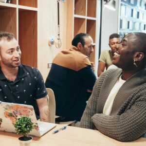 Colleagues engaging in a lively discussion at a contemporary coworking space.
