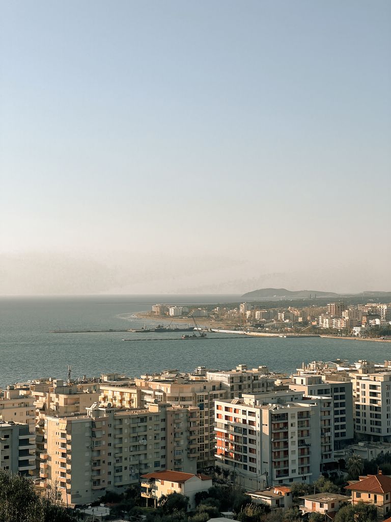 A coastal cityscape with residential buildings and sea view in Albania.