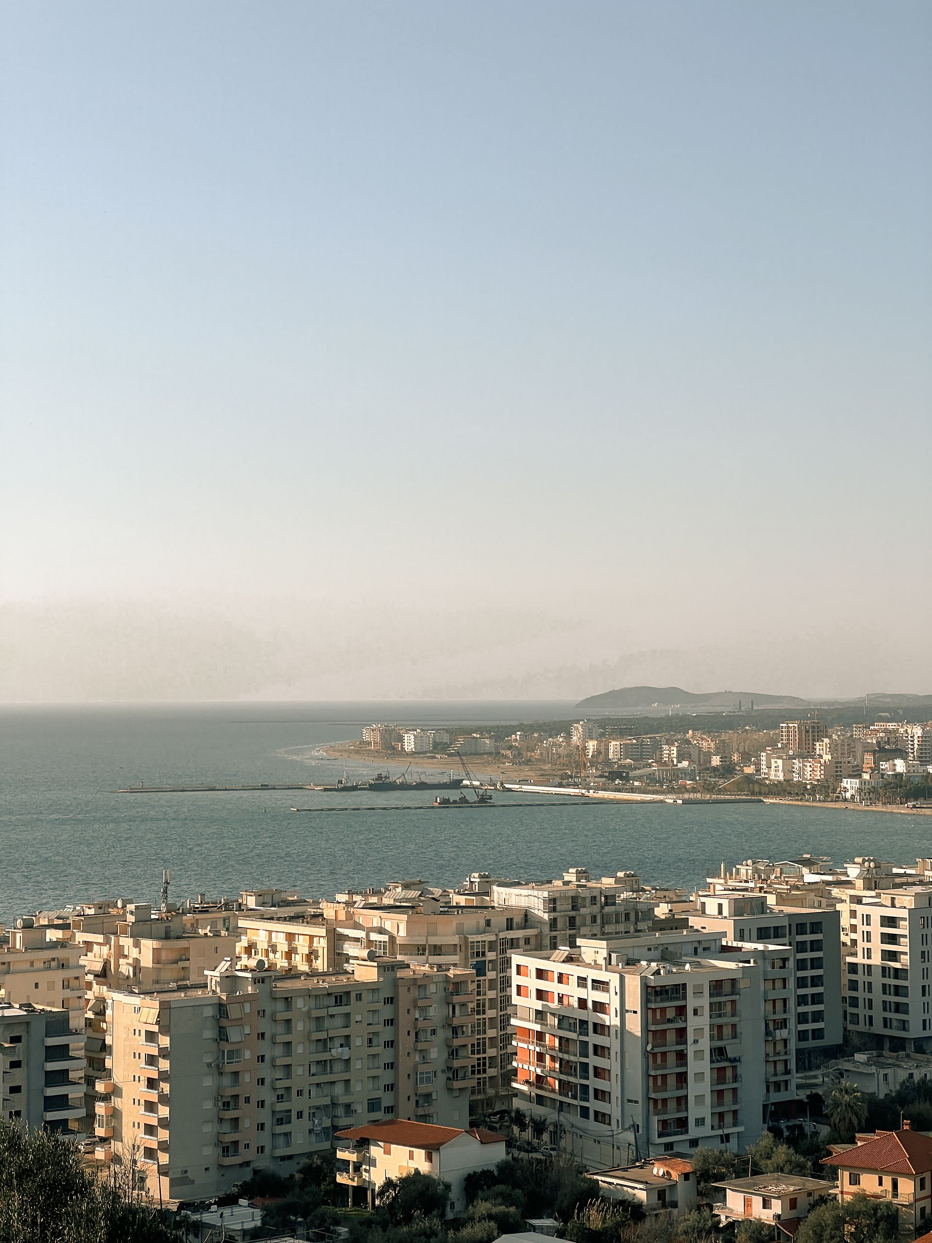 A coastal cityscape with residential buildings and sea view in Albania.